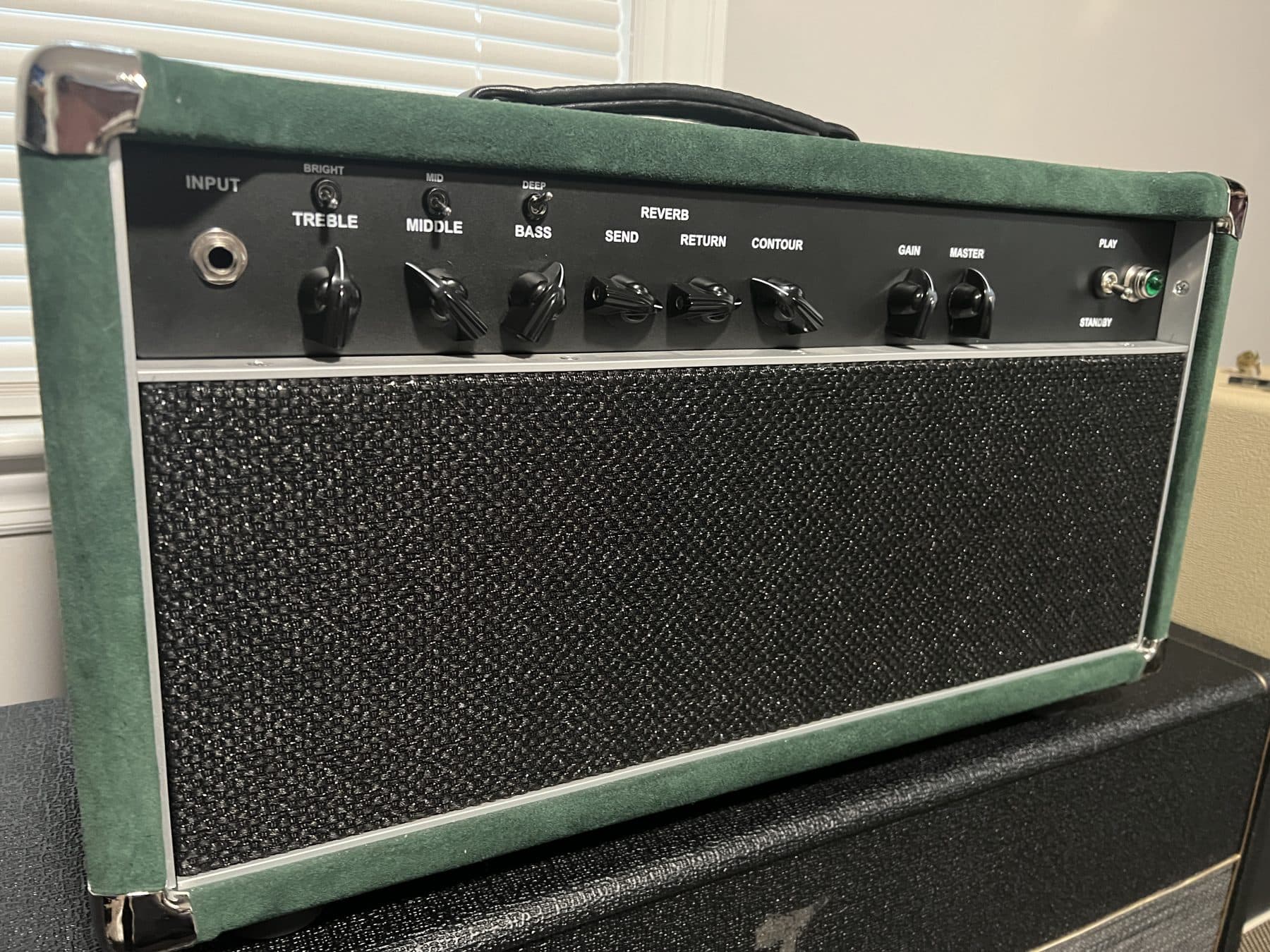 Green suede Daniel James amplifier head with treble, middle, bass, reverb and contour controls
